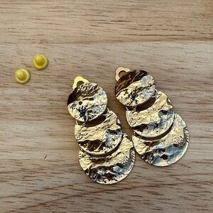 Gold Toned Textured Dangle Clip On Earrings